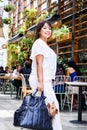 Young woman with a small dog in her bag. Royalty Free Stock Photo