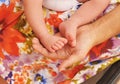 Young woman with the small feet of her baby in the hands Royalty Free Stock Photo