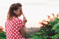 Young woman smelling flower in the garden Royalty Free Stock Photo