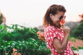 Young woman smelling flower in the garden Royalty Free Stock Photo