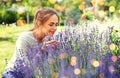 Young woman smelling lavender flowers in garden Royalty Free Stock Photo