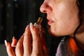 Young woman smelling perfume from a bottle Royalty Free Stock Photo