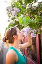 Young woman smelling white jasmin flowers Royalty Free Stock Photo