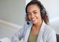 A young woman smiles to the camera wearing a headphone set with microphone Royalty Free Stock Photo