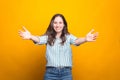 Young woman is smiling at the camera with arms wide open for hugs Royalty Free Stock Photo