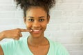 Young woman smiling confidence pointing finger showing teeth white. Royalty Free Stock Photo