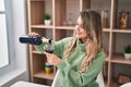 Young woman smiling confident pouring wine on glass at home Royalty Free Stock Photo