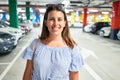 Young woman smiling confident at underground parking lot around cars and lights Royalty Free Stock Photo