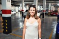 Young woman smiling confident at underground parking lot around cars and lights Royalty Free Stock Photo