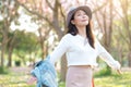 Young woman enjoying cherry blossom garden in morning Royalty Free Stock Photo