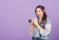 Young woman smiling excited wear denims holding vintage photo camera Royalty Free Stock Photo