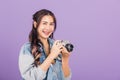 Young woman smiling excited wear denims holding vintage photo camera Royalty Free Stock Photo