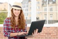 Young woman with smiling face holding laptop Royalty Free Stock Photo