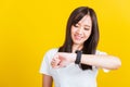 Young woman smiling looking and pointing finger her smart wristwatch Royalty Free Stock Photo