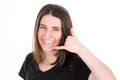 Young woman smiling making phone gesture with hand and fingers like talking on phone in communication concept