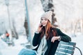 Young woman smiling with smart phone and winter landscape . Royalty Free Stock Photo