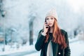 Young woman smiling with smart phone and winter landscape . Royalty Free Stock Photo