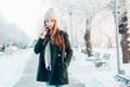 Young woman smiling with smart phone and winter Royalty Free Stock Photo