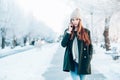 Young woman smiling with smart phone and winter landscape . Royalty Free Stock Photo