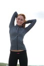 Young woman smiling and stretching muscles before workout