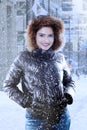 Young woman smiling under snowfall