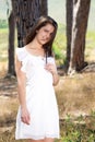 Young woman smiling in white dress in the woods Royalty Free Stock Photo