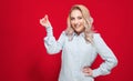 Young woman snapping fingers, isolated on red background. One cute girl gesturing click Royalty Free Stock Photo