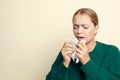 Woman sneezing on light background, space for text. Cold symptoms