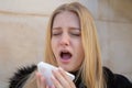 Woman sneezing in winter