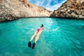 Young woman snorkeling in clear tropical water. Traveling, active lifestyle concept. Watersports on vacation