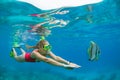 Young woman in snorkeling mask dive underwater with tropical fishes Royalty Free Stock Photo