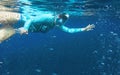 Young woman in snorkeling mask underwater photo. Snorkel in oxygen bubbles undersea. Snorkeling in tropical sea Royalty Free Stock Photo