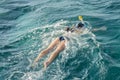 Young woman snorkeling in transparent shallow. Young woman at snorkeling in the tropical water. active woman free diving Royalty Free Stock Photo