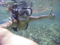 Young woman snorkelling with positive attitude