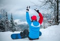 Young woman with snowboard high in mountains in winter season for sports activities