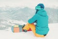 Snowboarder looking at mountains.