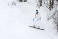 Young woman snowboarder in motion on snowboard in mountains Royalty Free Stock Photo