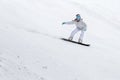 Young woman snowboarder in motion on snowboard in mountains Royalty Free Stock Photo