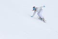 Young woman snowboarder in motion on snowboard in mountains Royalty Free Stock Photo