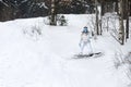 Young woman snowboarder in motion on snowboard in mountains Royalty Free Stock Photo