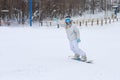 Young woman snowboarder in motion on snowboard in mountains Royalty Free Stock Photo