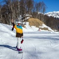 Young woman snowboarder in mountains Royalty Free Stock Photo