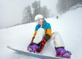 Young woman snowboarder in mountains