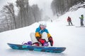 Young woman snowboarder in mountains