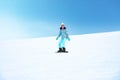 Young woman snowboarding on hill at mountain resort. Winter vacation Royalty Free Stock Photo