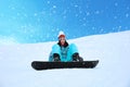 Young woman snowboarding on hill at resort. Winter vacation Royalty Free Stock Photo