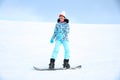 Woman snowboarding on hill at mountain resort. Winter vacation Royalty Free Stock Photo
