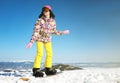 Young woman snowboarding on hill. Winter vacation Royalty Free Stock Photo