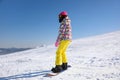 Young woman snowboarding on hill Royalty Free Stock Photo