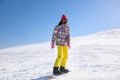 Young woman snowboarding on hill Royalty Free Stock Photo